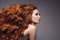 Portrait of woman with long curly beautiful ginger hair.