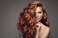 Portrait of woman with long curly beautiful ginger hair.