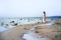 Woman in a long dress on the shore Royalty Free Stock Photo