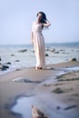 Woman in a long dress on the shore Royalty Free Stock Photo