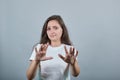 Woman with long hair ahead isolated gray wall making stop gesture