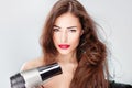 Woman with long hair holding blow dryer Royalty Free Stock Photo