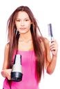 Woman with long hair holding blow dryer and comb Royalty Free Stock Photo