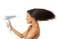 Woman with long hair holding blow dryer Royalty Free Stock Photo