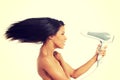 Woman with long hair holding blow dryer Royalty Free Stock Photo