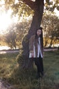 Woman with long hair in leopard shirt relaxing in green forest enjoys the silence and beauty of nature. Royalty Free Stock Photo