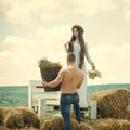 Woman with long hair stand on bench with flowers Royalty Free Stock Photo