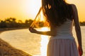 Woman with long hair at sunset