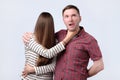 Angry woman try to strangle husband, studio shot