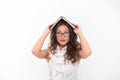 Woman with long hair white blouse hold book as roof. Teacher with glasses looks attractive. Seductive office