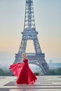 Woman in long red dress dancing near the Eiffel tower in Paris, France Royalty Free Stock Photo