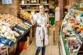 Woman with long shopping list in the supermarket Royalty Free Stock Photo