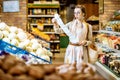 Woman with long shopping list in the supermarket Royalty Free Stock Photo