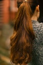 woman with long thick brown hair pony tale close up photo on green summer garden background Royalty Free Stock Photo