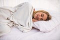 Woman with long white hair lying and sleeping in bed Royalty Free Stock Photo