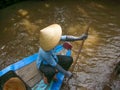 Woman in a longboat in Vietnam with her tipycal hat