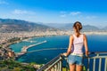 Woman look on landscape of Alanya with marina and Kizil Kule red tower in Antalya district, Turkey, Asia. Famous tourist Royalty Free Stock Photo