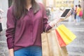 Woman look at mobile phone with paperbags in the mall while enjoying a day shopping Royalty Free Stock Photo