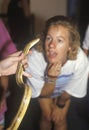 A woman looking at an Albino Python snake