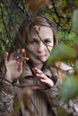 Woman Looking through Autumn Branches