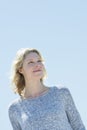 Woman Looking Away While Smiling Against Clear Sky Royalty Free Stock Photo