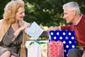 Woman looking in bag at gift from husband Royalty Free Stock Photo