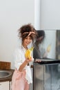 Woman looking at bananas near fridge Royalty Free Stock Photo