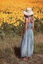 Woman looking at beautiful sunflower field Royalty Free Stock Photo