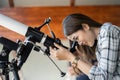 Woman looking through telescope