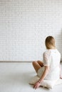 Woman looking on black white wall