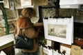 Woman looking at a Book, Bouquinists neer the Seine River in Paris