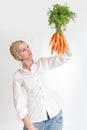 Woman looking at a bunch of carrots Royalty Free Stock Photo