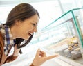 Woman looking at cake display in window