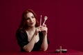 Woman smiling while holding makeup brushes standing against an isolated background. Royalty Free Stock Photo