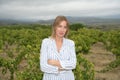 Woman looking at camera in a vineyard on a windy day Royalty Free Stock Photo