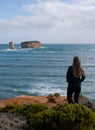 A woman looking at the cliffs in the Bay of Islands area at the Great Ocean Road in Australia