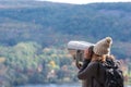 Woman looking through coin operated binoculars Royalty Free Stock Photo