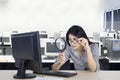 Woman looking at computer with magnifying glass Royalty Free Stock Photo