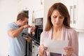 Woman Looking Concerned At Repair Bill Royalty Free Stock Photo