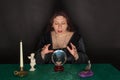 A woman is looking into a crystal ball