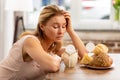 Woman looking at dairy and pastry products having strong allergy Royalty Free Stock Photo