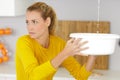 Woman looking at damage after water pipe leak Royalty Free Stock Photo