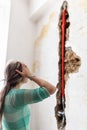 Woman looking at damage after a water pipe leak Royalty Free Stock Photo