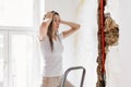 Woman looking at damage after a water pipe leak Royalty Free Stock Photo