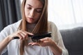 Woman looking at damaged hair tips