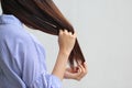 Woman looking at damaged splitting ends of hair, Haircare concept Royalty Free Stock Photo