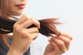 Woman looking at damaged splitting ends of hair, Haircare concept Royalty Free Stock Photo