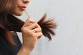 Woman looking at damaged splitting ends of hair, Haircare concept Royalty Free Stock Photo