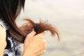 Woman looking at damaged splitting ends of hair, Haircare concept Royalty Free Stock Photo