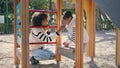 Woman looking daughter game standing on playground. Mom enjoying time together Royalty Free Stock Photo